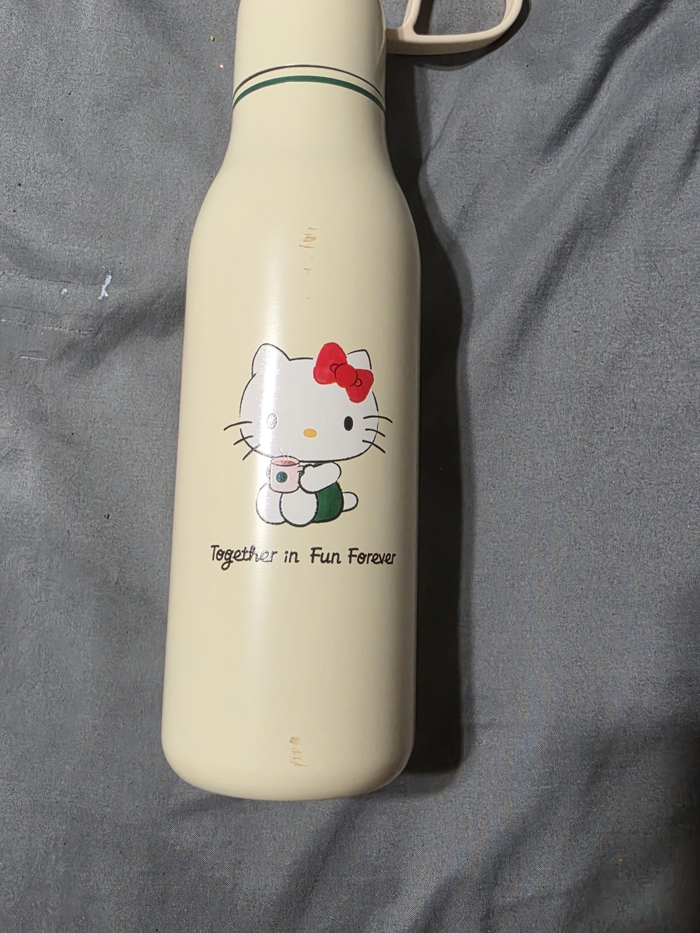 Hello Kitty Cream Water Bottle with Red Bow and Green Accents